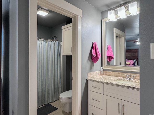 ensuite bathroom featuring a shower with shower curtain, toilet, connected bathroom, vanity, and tile patterned flooring