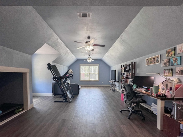 office space with lofted ceiling, a textured ceiling, visible vents, and wood finished floors