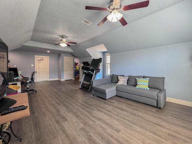 living area featuring lofted ceiling, visible vents, a ceiling fan, wood finished floors, and baseboards