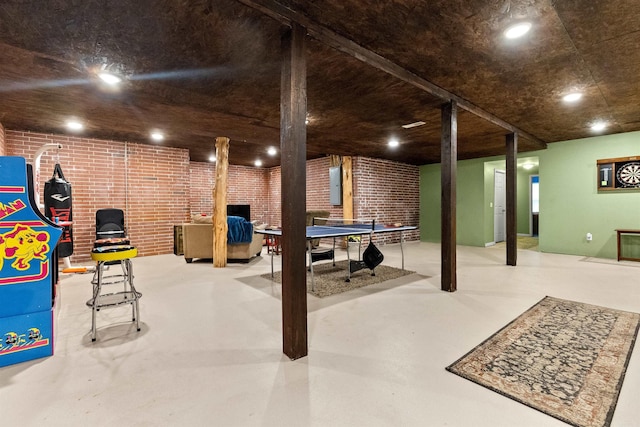 finished basement featuring brick wall