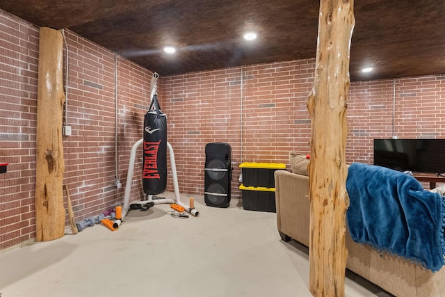 exercise room featuring brick wall and recessed lighting