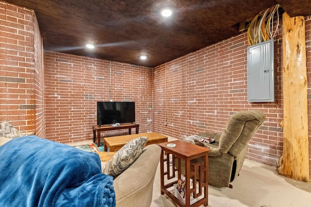 living room with recessed lighting, electric panel, concrete floors, and brick wall