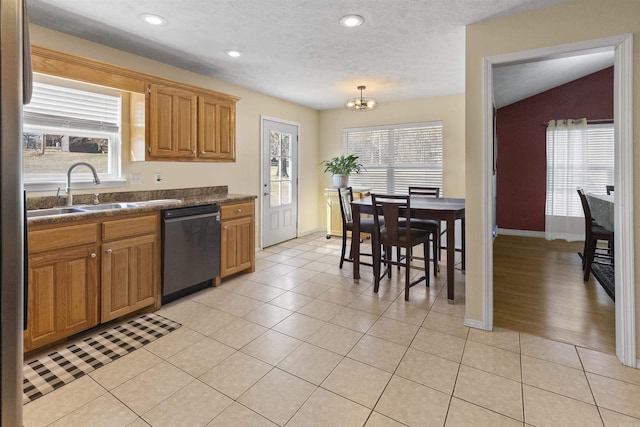 kitchen featuring light tile patterned floors, dark countertops, recessed lighting, a sink, and dishwasher