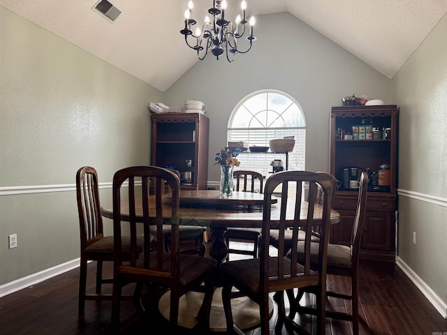 dining space featuring dark wood finished floors, lofted ceiling, visible vents, an inviting chandelier, and baseboards