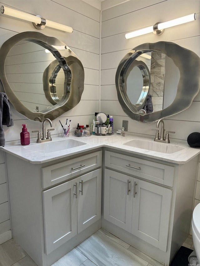 full bathroom with a sink and double vanity