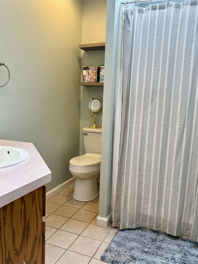 full bathroom featuring curtained shower, toilet, vanity, baseboards, and tile patterned floors