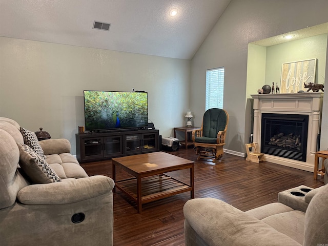 living area featuring baseboards, visible vents, lofted ceiling, dark wood-type flooring, and a fireplace