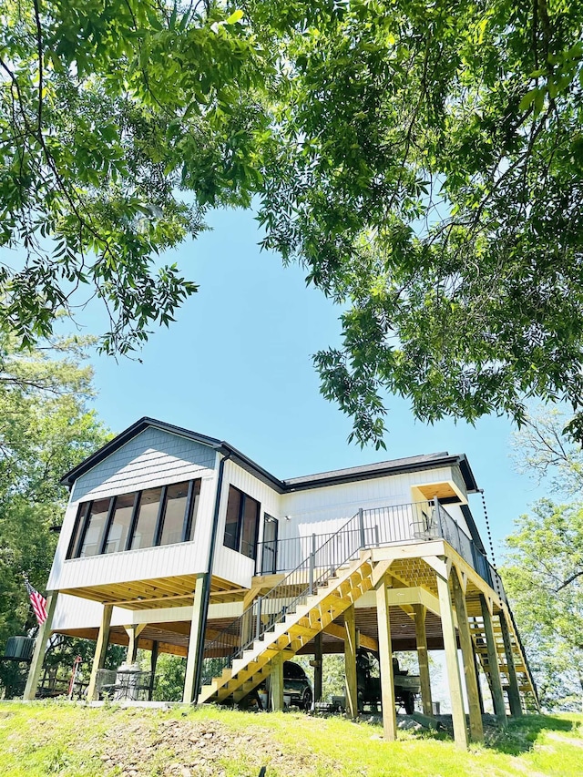 rear view of property featuring stairs