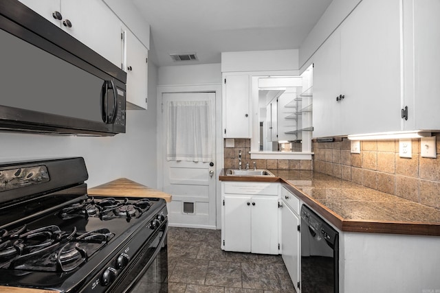 kitchen featuring tile counters, visible vents, white cabinetry, a sink, and black appliances