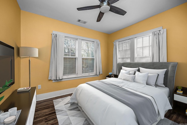 bedroom with visible vents, ceiling fan, baseboards, and wood finished floors