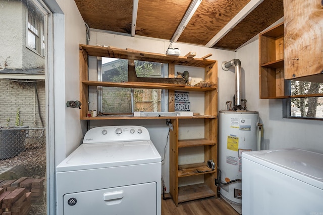 clothes washing area featuring laundry area, washer and dryer, gas water heater, and wood finished floors