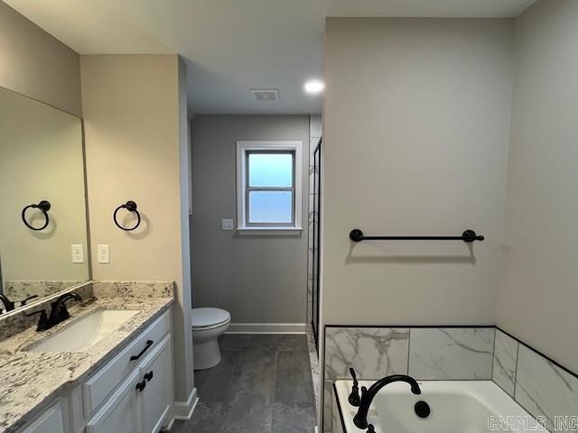 full bathroom featuring a garden tub, toilet, wood finished floors, vanity, and baseboards