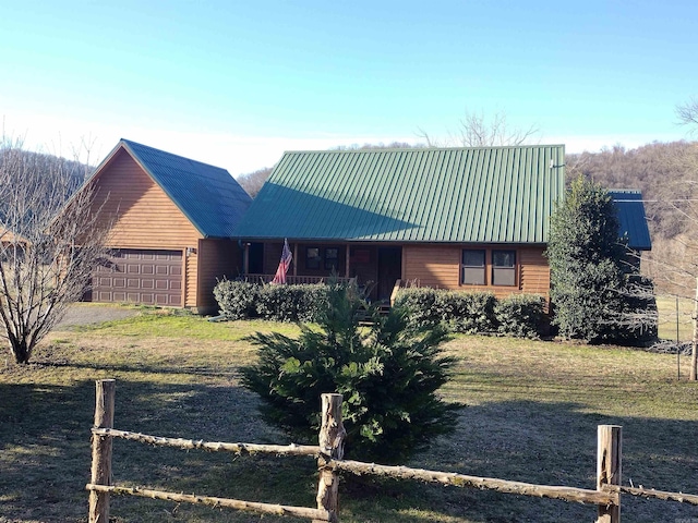 view of front of home with a porch, metal roof, and an attached garage