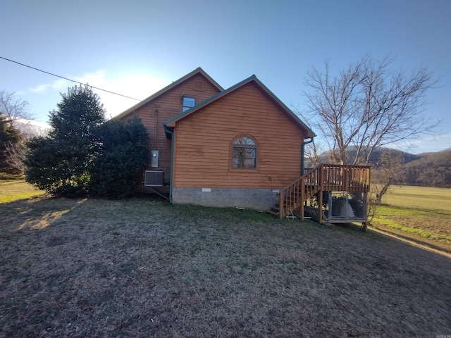 view of side of home featuring stairs, a yard, crawl space, and a wooden deck
