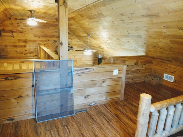 bonus room with wood walls, visible vents, wood ceiling, vaulted ceiling, and dark wood-style floors