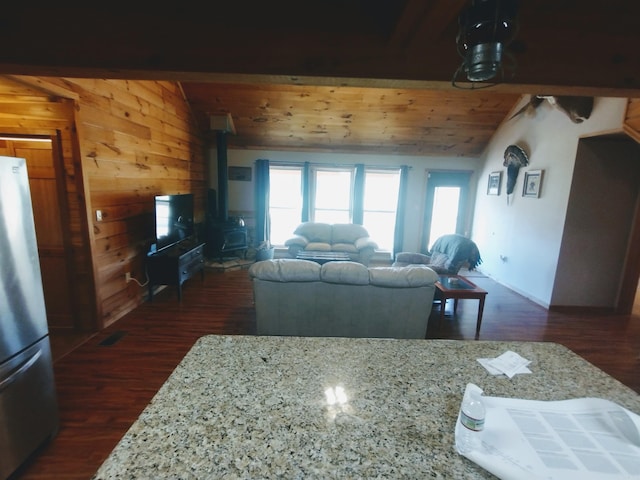 kitchen featuring wooden ceiling, dark wood-style floors, freestanding refrigerator, a wood stove, and vaulted ceiling
