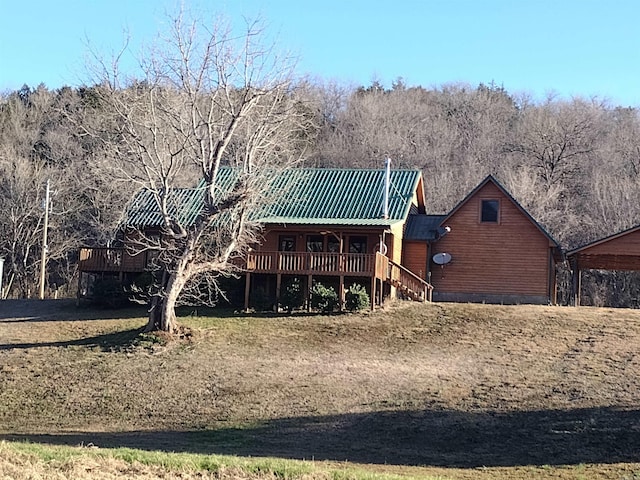 rear view of house with a wooden deck