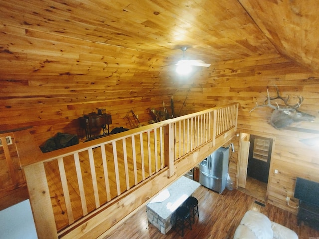 bonus room featuring lofted ceiling, wooden ceiling, wood walls, and wood finished floors