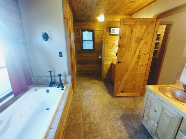 full bath featuring wooden ceiling, wood walls, vanity, and a whirlpool tub