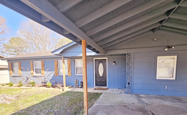 property entrance featuring brick siding