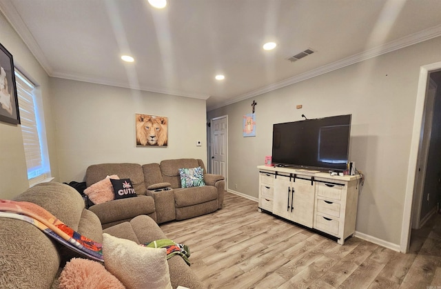 living area featuring ornamental molding, baseboards, visible vents, and light wood finished floors