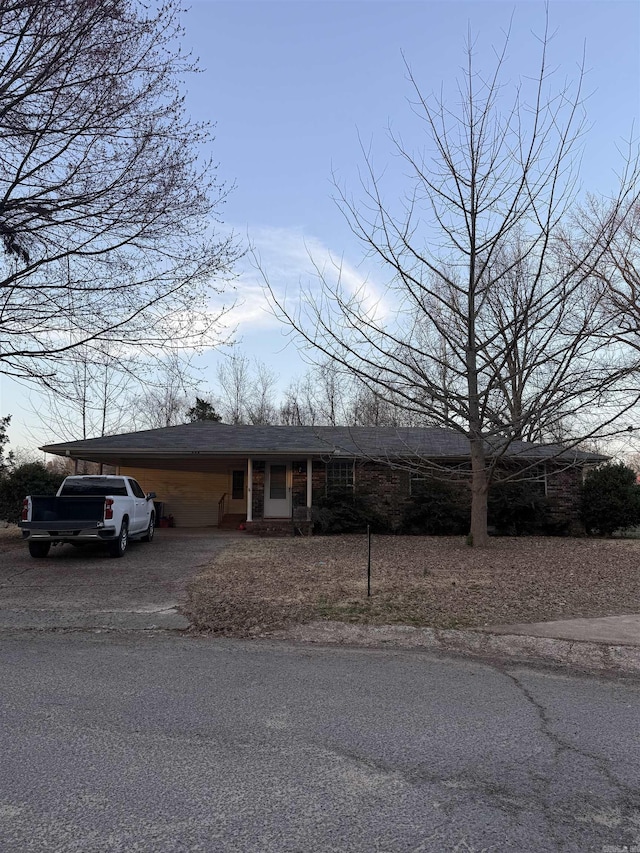 view of front facade featuring a carport and aphalt driveway