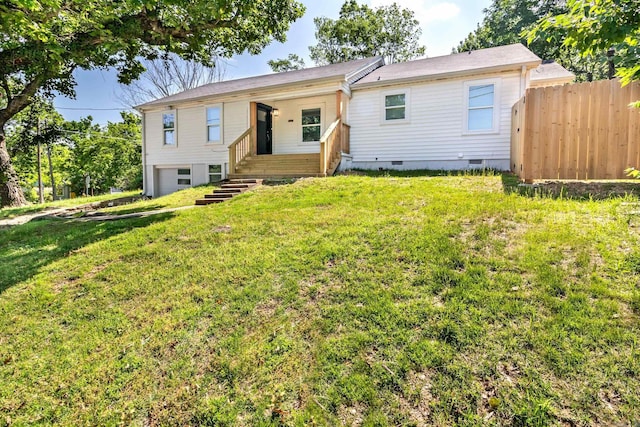 ranch-style house with crawl space, a garage, fence, and a front lawn