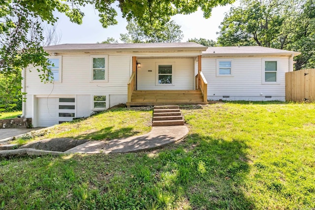 view of front of property featuring a porch, a garage, fence, crawl space, and a front lawn