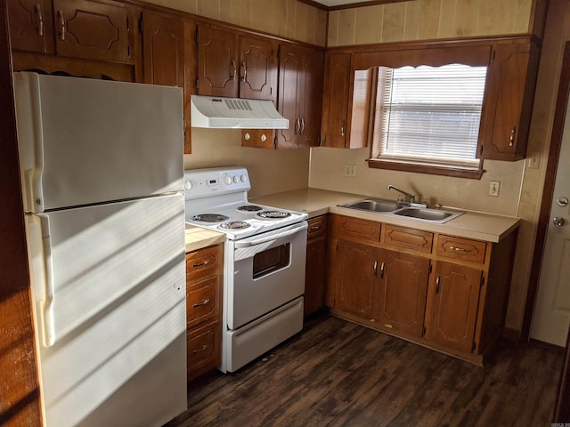 kitchen with electric stove, freestanding refrigerator, light countertops, under cabinet range hood, and a sink