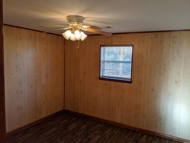 spare room with a ceiling fan, visible vents, baseboards, and dark wood-type flooring