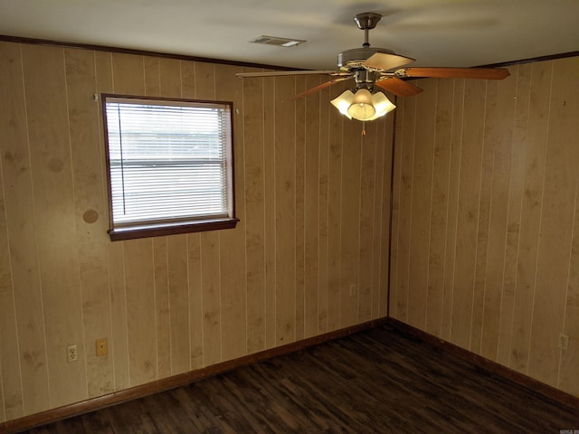 spare room featuring a ceiling fan, baseboards, visible vents, and dark wood-style flooring