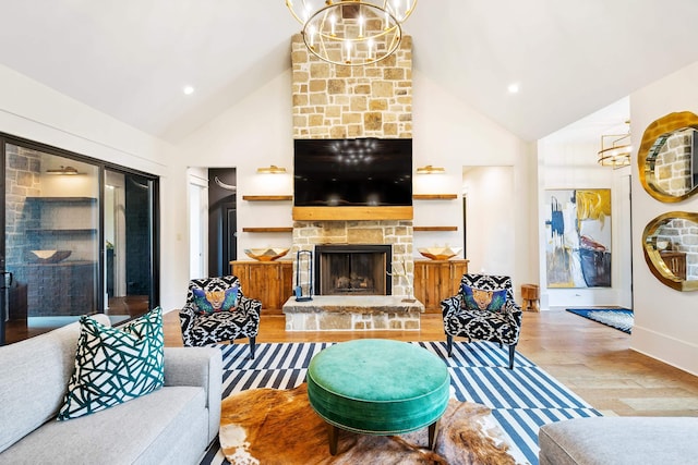 living area featuring high vaulted ceiling, a chandelier, wood finished floors, and a stone fireplace