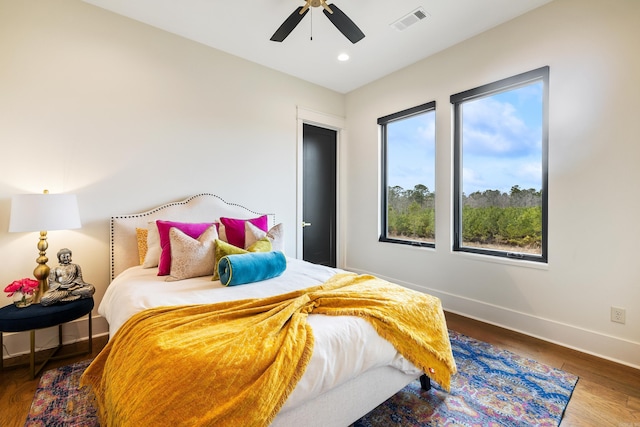 bedroom featuring ceiling fan, recessed lighting, wood finished floors, visible vents, and baseboards