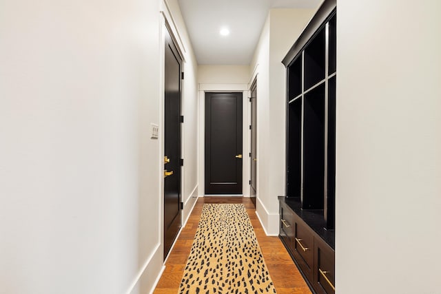 interior space with recessed lighting, wood finished floors, and baseboards