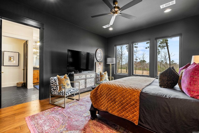 bedroom featuring wood finished floors, visible vents, and recessed lighting