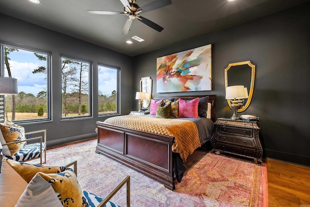 bedroom with visible vents, baseboards, wood finished floors, and recessed lighting