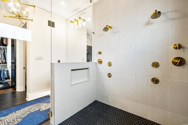 bathroom featuring tile patterned flooring and a tile shower