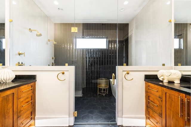 bathroom featuring tile walls, recessed lighting, vanity, a walk in shower, and tile patterned flooring