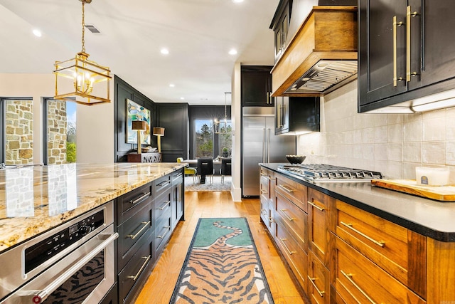 kitchen with custom exhaust hood, stainless steel appliances, visible vents, backsplash, and light wood-style floors