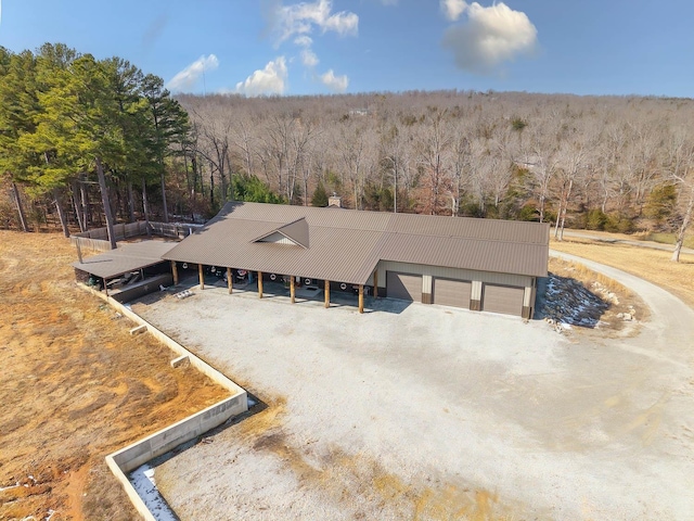 birds eye view of property with a wooded view