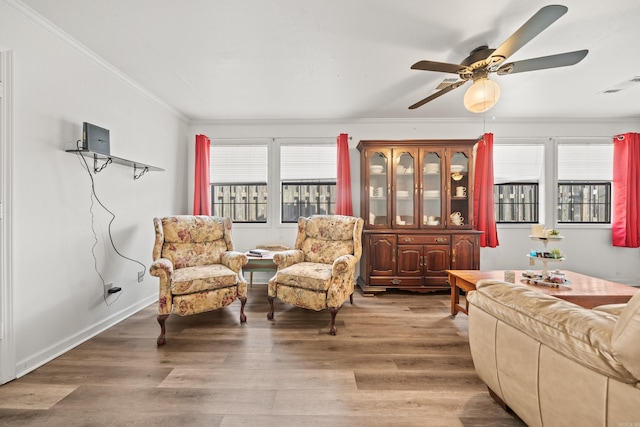 sitting room featuring light wood-type flooring, visible vents, and plenty of natural light