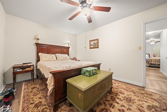 bedroom featuring baseboards, ceiling fan, and light wood finished floors