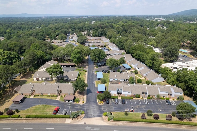 birds eye view of property featuring a forest view and a residential view