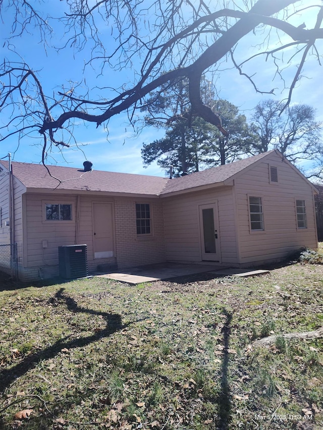 back of property with central air condition unit and a patio area