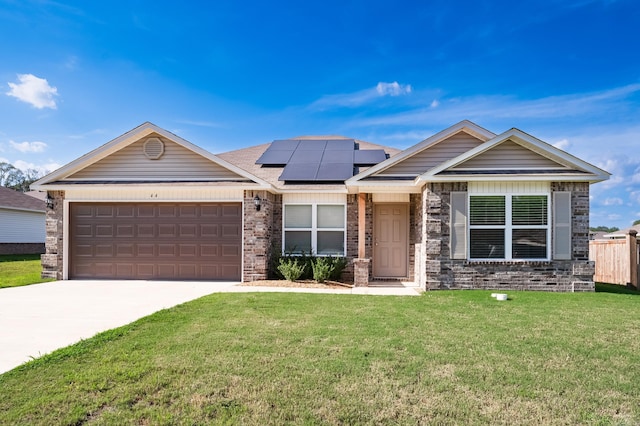 single story home featuring solar panels, concrete driveway, an attached garage, a front lawn, and brick siding