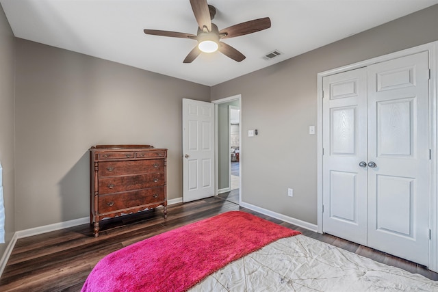 bedroom featuring a closet, wood finished floors, visible vents, and baseboards