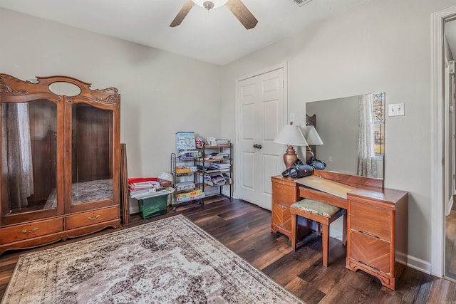 home office featuring ceiling fan, dark wood-type flooring, and baseboards