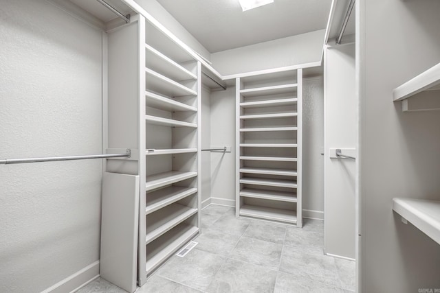 spacious closet featuring light tile patterned floors