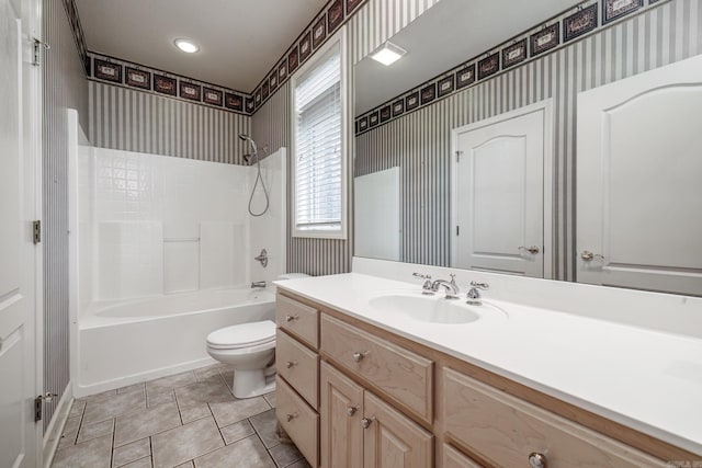 bathroom with shower / bathing tub combination, vanity, toilet, and wallpapered walls