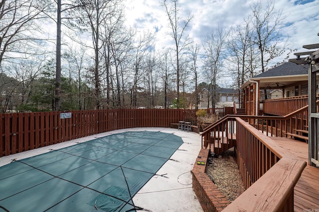 view of swimming pool featuring fence, a fenced in pool, and a wooden deck